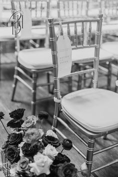 black and white photo of chairs with flowers on them