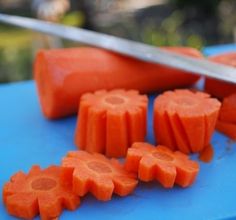 carrots are cut up on a blue cutting board