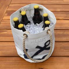 six bottles of seabrews beer in a white bag with rope handles