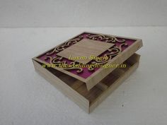 a wooden box with purple and black designs on it