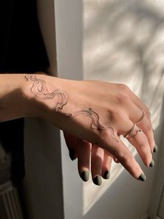 a woman's hand with a tattoo on it