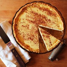 there is a pie on the table with a slice cut out and a knife next to it