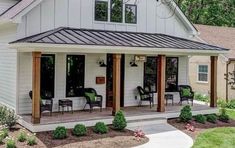 a small white house with porch and covered patio