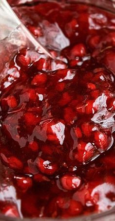 pomegranate is being poured into a glass bowl