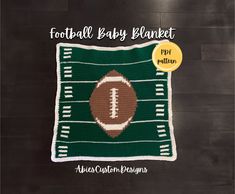 a crocheted football baby blanket on a wooden floor with the words football baby blanket written across it