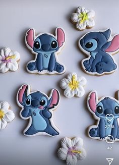 the cookies are decorated with blue and pink fondant designs, including lillies on them