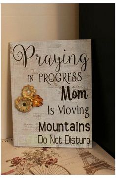 a sign that says praying in progress mom is moving mountains do not disturb