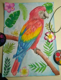 a colorful parrot sitting on top of a tree branch next to paintbrushes and paints