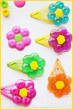 colorful plastic hair clips with flowers and beads on white table top next to other items