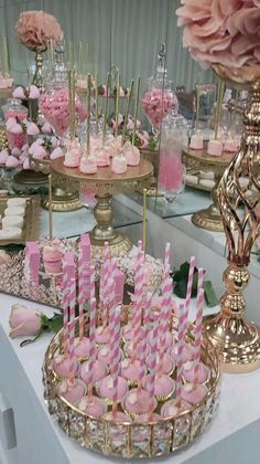 pink and gold dessert table with cupcakes, candy bars and flowers