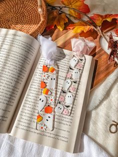 an open book sitting on top of a wooden table next to scissors and other items