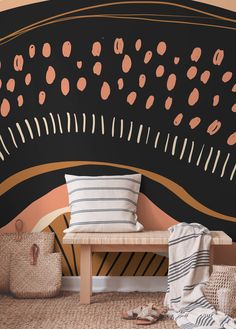 a black and gold wall with some pink dots on it, next to a wooden bench