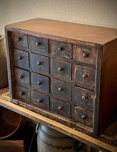 an old wooden dresser with many drawers and knobs on it's front shelf