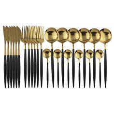 an assortment of gold and black forks, knives and spoons on a white background