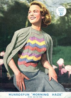 a woman is sitting on a bench wearing a striped sweater and skirt with an open jacket over her shoulders