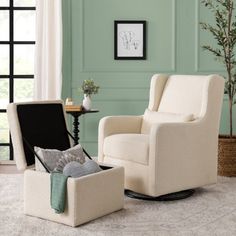 a chair and ottoman in a living room with green walls, white curtains and rugs