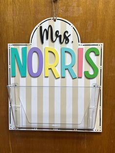 a sign that says mrs norris hanging on a door