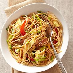 a white bowl filled with pasta and vegetables