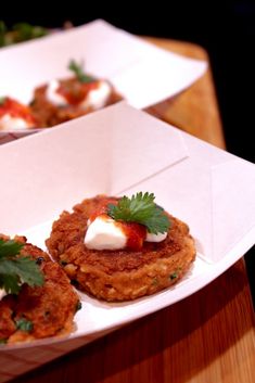 some food that is on top of a white paper plate and sitting on a wooden table