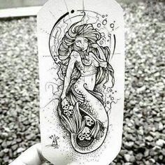 a drawing of a mermaid on the back of a hand