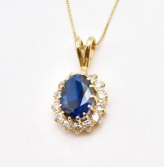 Gold Sapphire Pendant set with a Created Sapphire in a flawless clarity & stunning blue color, at 14x10mm (6 Cts). Surrounded by CZ Diamonds. Gold Vermeil: 18k Gold over Solid 925 Sterling Silver ☞ made to last. Matching Ring: www.etsy.com/listing/1586354183 Matching Earrings: www.etsy.com/listing/1586385377   September Birthstone - Genuine & Natural Stones ❀  Details :  ♥ Each item comes in a cute GIFT BOX ✓  ♥ GUARANTEE on the materials ✓ ♥ Created Sapphire in a flawless clarity & CZ Diamonds Sapphire And Diamond Pendant, Blue Diamond Oval Pendant Necklace, Oval Blue Cubic Zirconia Necklaces, Oval Blue Cubic Zirconia Necklace, Formal Blue Necklace With Halo Setting, Formal Blue Necklaces With Halo Setting, Necklace Princess, Matching Ring, Cute Gift Boxes