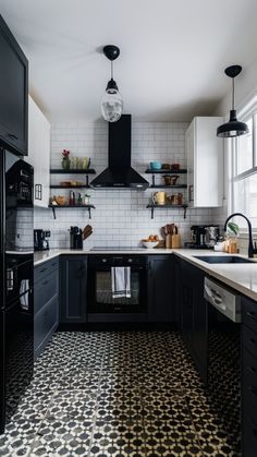 a black and white kitchen with tile flooring