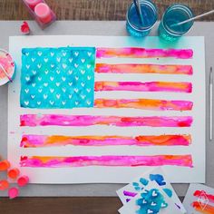 an american flag made out of melted paint and watercolors on a piece of paper