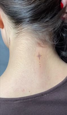 a woman with a cross tattoo on her neck