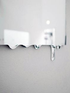 a bathroom mirror with water dripping from it