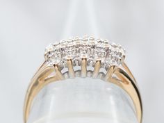 a ring with three rows of diamonds on it's side, in front of a white background