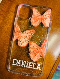 the phone case has three butterflies on it