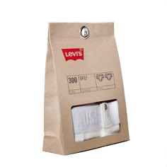 two rolls of white toilet paper in a brown bag with the label levi's on it