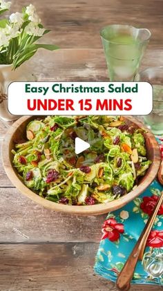 a wooden bowl filled with salad on top of a table