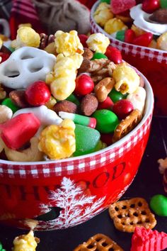 two red bowls filled with christmas treats on top of a table