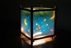 an illuminated box with stars and the moon on it