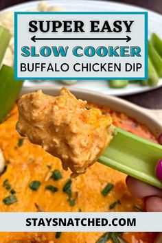 a hand holding up a spoon full of slow cooker buffalo chicken dip with celery