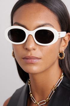 CELINE Eyewear's sunglasses have been made in Italy from white acetate and have modern oval-shaped frames. They're adorned with an archival logo plaque - first introduced by the label's founder in 1973 - and fitted with dark lenses. Celine Eyewear, Celine Triomphe, White Sunglasses, Celine Sunglasses, Gucci Eyewear, Acetate Sunglasses, Trending Sunglasses, Cool Sunglasses, Oval Sunglasses