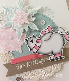 a close up of a christmas card with a bear on the sleigh and snowflakes