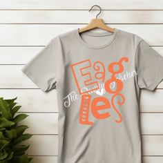 Get ready to show off your school spirit with our Eagles Fun Spirit Shirt. Made from athletic grey and heathered grey materials, this shirt is both functional and fun. With a bold orange Eagles design, it's perfect for any fan or athlete. Add it to your wardrobe and show off your love for your team! Orange Team Spirit T-shirt With Letter Print, Orange T-shirt With Team Spirit Letter Print, Sporty Orange T-shirt For College, School Spirit Gray Tops With Team Name, Eagles Design, Eagle Design, Spirit Shirts, French Guiana, British Virgin Islands