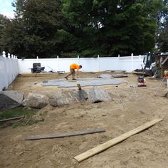 construction workers are working on the back yard