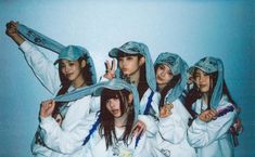 four girls in white hoodies posing for the camera