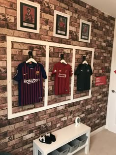 there are several soccer jerseys hanging on the wall