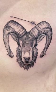 a ram tattoo on the back of a woman's chest