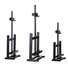 three black metal stands with one standing and the other sitting on it's sides