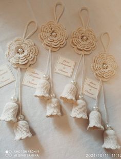 small crocheted bells with name tags attached to them