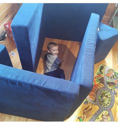 a young boy sitting in a blue chair