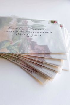 a stack of folded wedding cards with the words, happily married on them and flowers