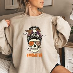 This trendy Momster Skeleton Halloween sweatshirt is the perfect way to represent your love for Halloween.  Comes in multiple colors! ❤️ Please note that for the oversized look you need to buy 1-3 sizes larger than you normally wear. If you prefer the standard Unisex fit order your typical size. For women, if you prefer a more women's fit sweatshirt please size down 1 size, as this sweatshirt is a Unisex fit ❤️ This unisex heavy blend crewneck sweatshirt is relaxation itself. The material is a t Trendy Skull Shaped Tops For Fall, Halloween Cotton Sweatshirt With Skull Print, Halloween Cotton Sweatshirt With Skull Design, Trendy Crewneck Sweatshirt, Trendy Crewneck, Skeleton Halloween, Trendy Halloween, Funny Mom, Funny Sweatshirts