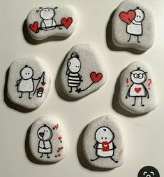 six painted rocks with cartoon characters on them, one holding a heart and the other holding a knife