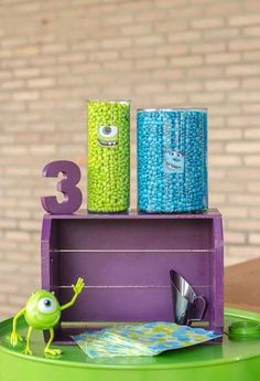 two cans are stacked on top of each other in the shape of monsters and numbers